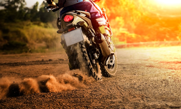 man riding sport touring motorcycle on dirt field