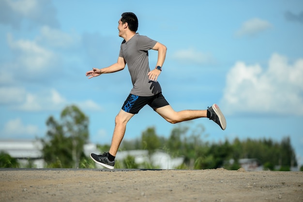 Man runner on the road to healthy, Young people running exercise on street.