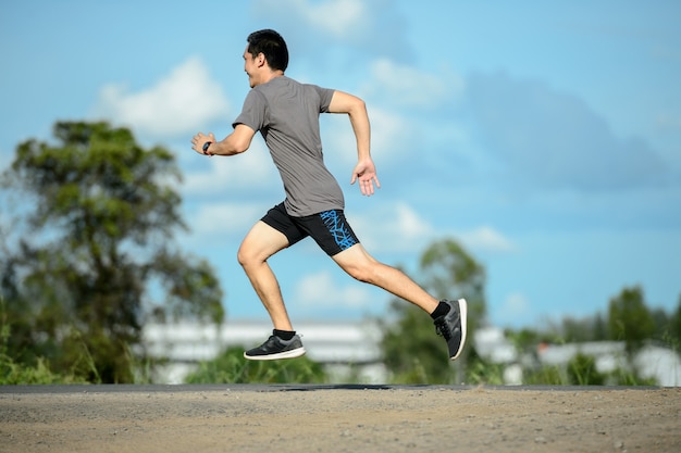 Man runner on the road to healthy, Young people running exercise on street.