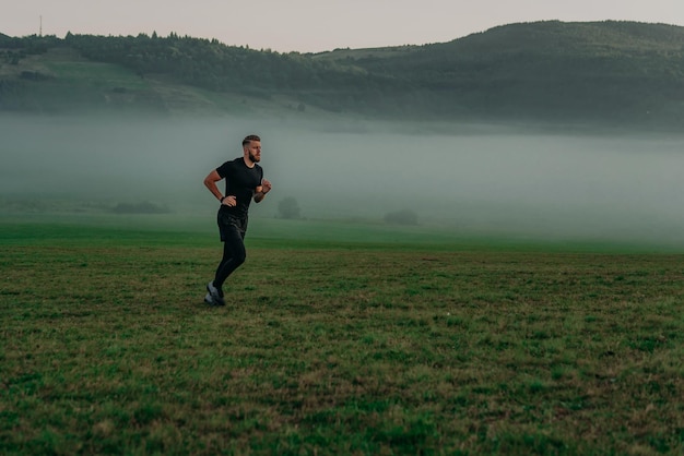 Man running on meadow in morning time