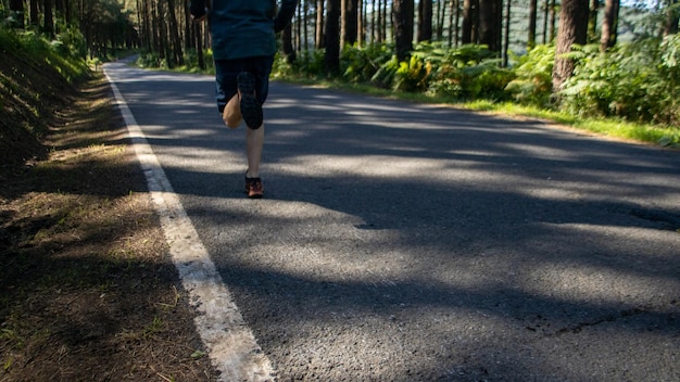 Man running on the road in the middle of nature Running outdoors as a lifestyle Healthy habits