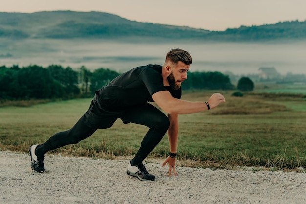 Man running / sprinting on road in mountains. Fit male fitness runner during outdoor workout. Young caucasian man.