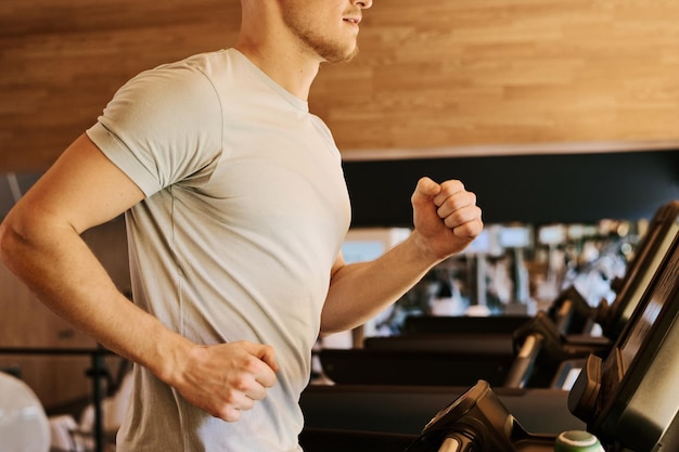 Man running on treadmill in gym