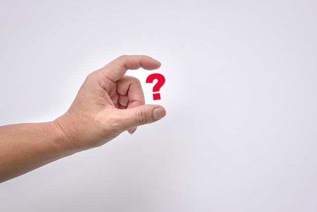 Man's fingers virtually hold a red question mark on white background