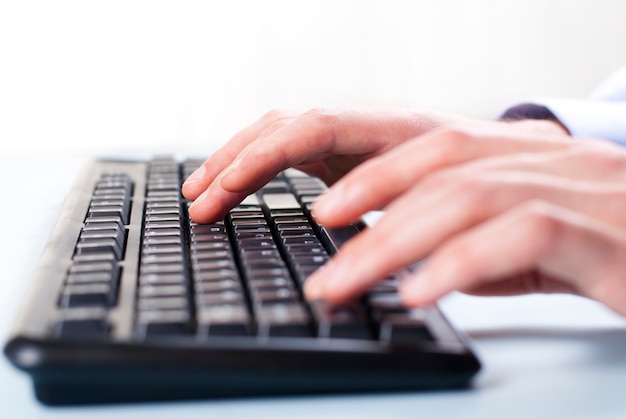 Man's hand on computer keyboard woman's hand on the keyboard typing