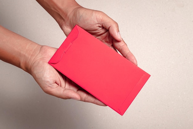 Man's hand hold with chinese red envelopeon white background