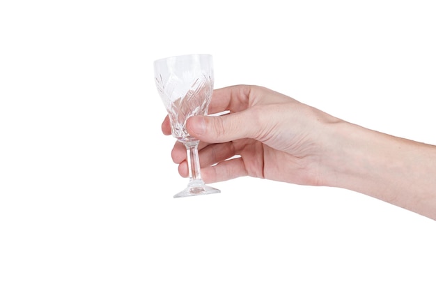 Man's hand holding a glass for vodka isolated on white. Space for text.