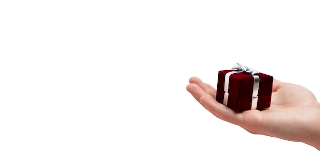 Man's hand holds a red box on white background Wedding concept Valentine's day Copy space