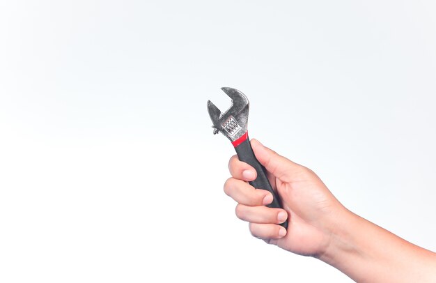 Man's hand holds a wrench on white background.