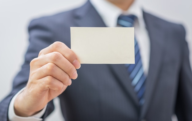 Man's hand showing business card 