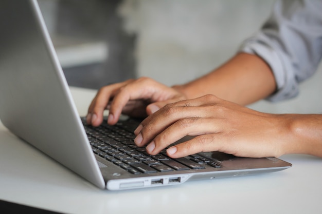 Man's hands are using a computer notebook to Searching for information.