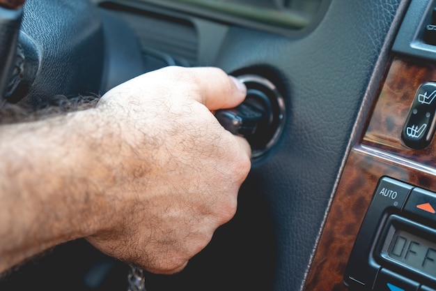 Photo man's hands to take the keys to start the engine car.