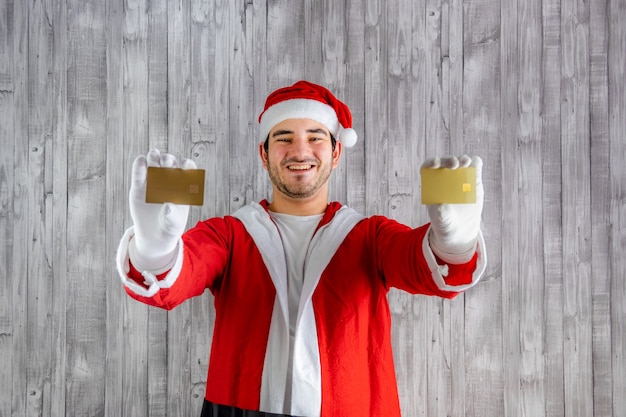 Man in Santa Claus costume with two credit cards