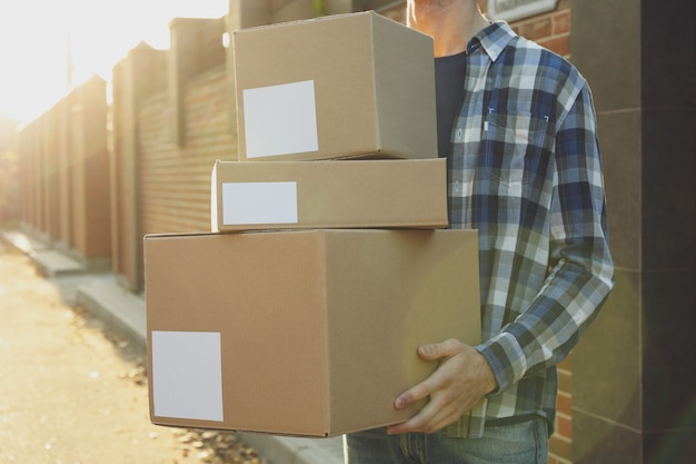 Man in shirt hold blank boxes outdoor, space for text