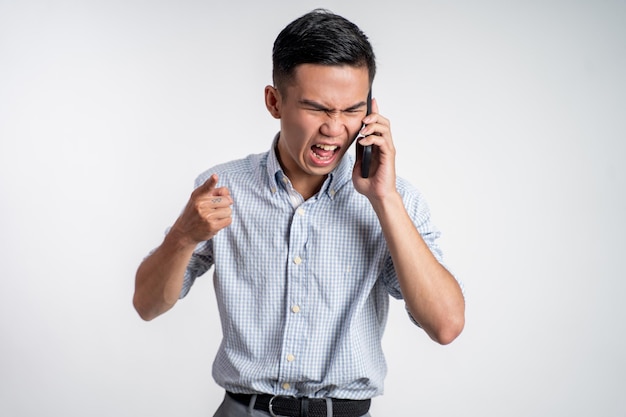 Man shocked and angry while talking on his smartphone