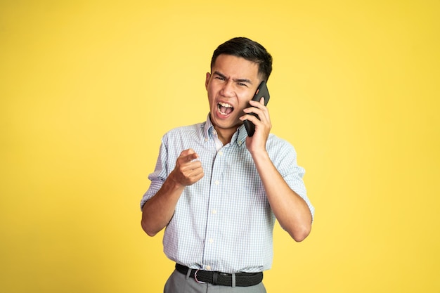 Man shocked and angry while talking on his smartphone