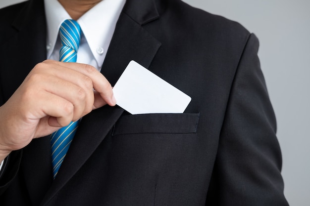 The Man showing a business cards in suit