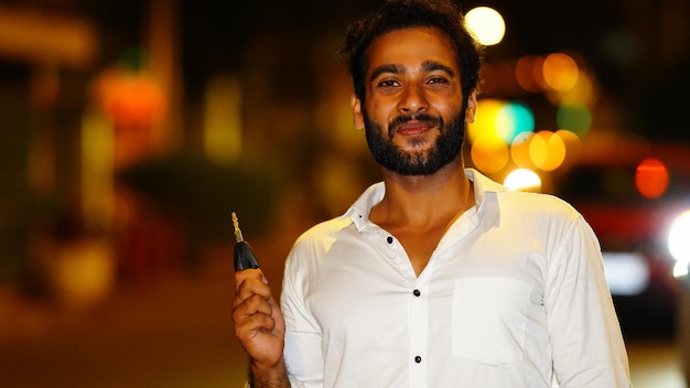 Man showing car key outdoor shoot