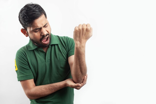 Man showing elbow joint pain with a grimaced expression