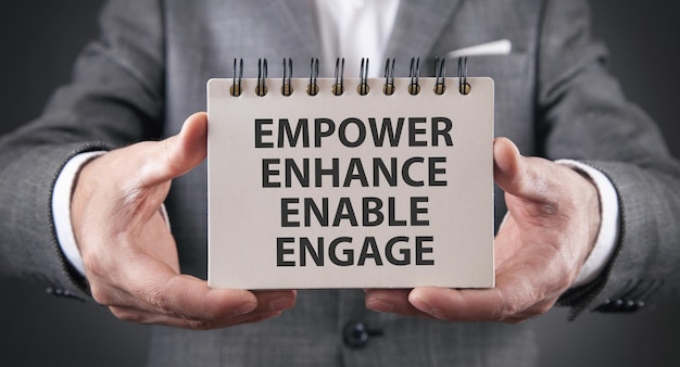 Man showing Empower Enhance Enable Engage concept