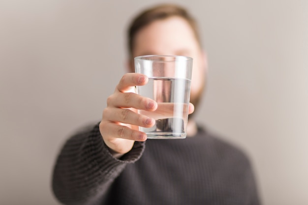 Man showing glass of water