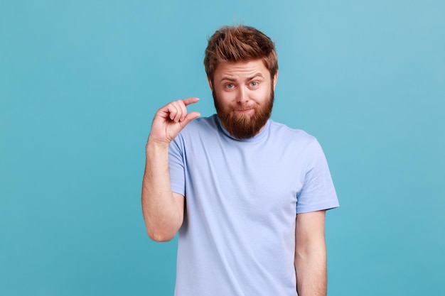 Man showing a little bit gesture dissatisfied with low rating measuring scale frowning face