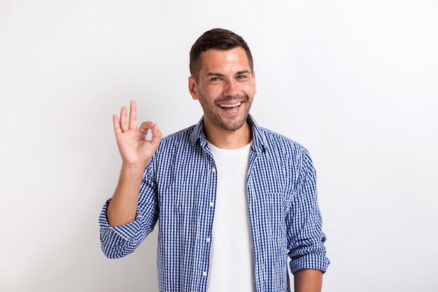 Man showing ok gesture in studio