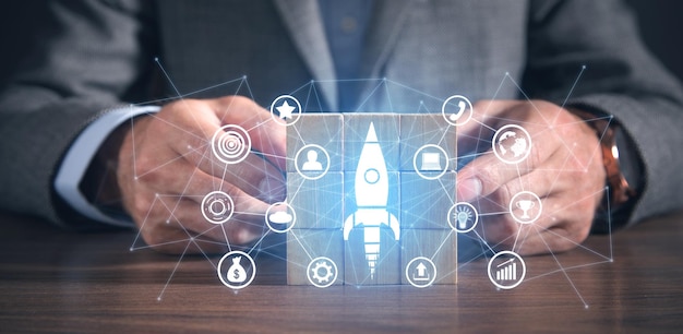 Man showing rocket with a business icons and network Business Startup