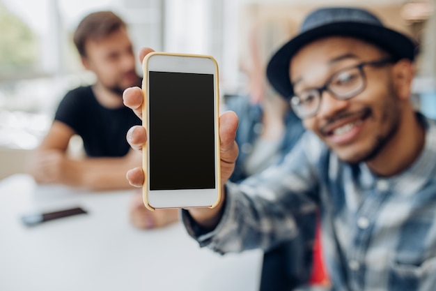 Photo man showing smartphone with empty screen