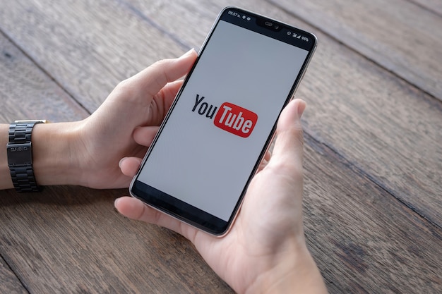 Man showing Youtube app on Smartphone