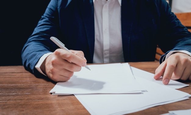 Man sign a home insurance policy on home loans. Estate agent with customer before contract signature.