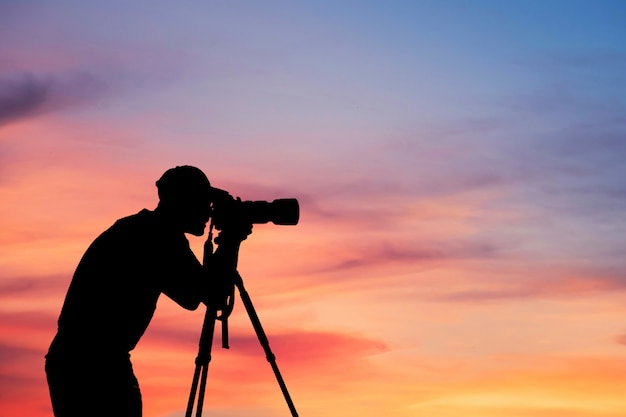 Man Silhouette Photographer take photo on hill high mountain professional camera shooting photo landscape sunset on top mountain nature twilight sky