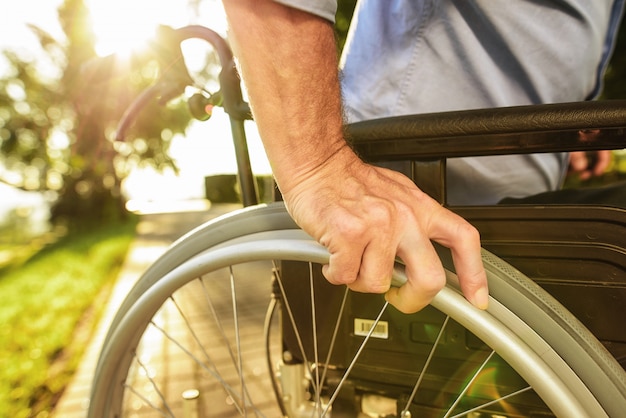 Man Sit in Wheelchair . Disabled Assistance .