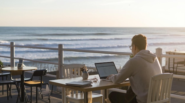 Photo a man sits at a table with a laptop and a bottle of wine