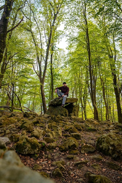 A man sitting in the Aitzetako Txabala Dolmen in the Basque Country Errenteria Gipuzkoa