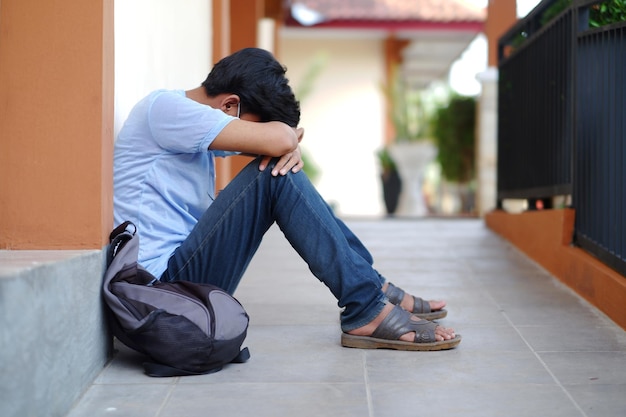 A man sitting alone feeling sad, depressed, stressed