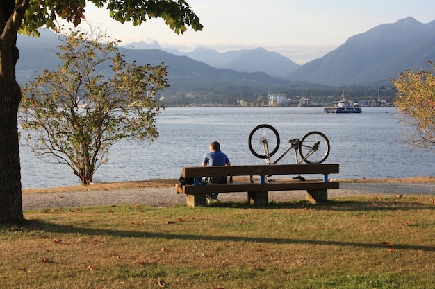 Man sitting on a bench with his bike Vancouver Canada