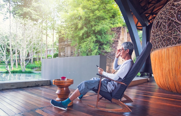 Man sitting on a chair and using a phone