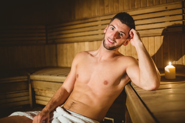 Man sitting inside a sauna