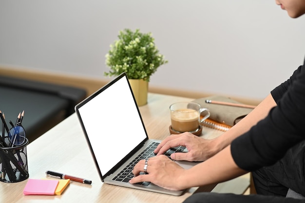 Man sitting in living room and surfing internet wit laptop