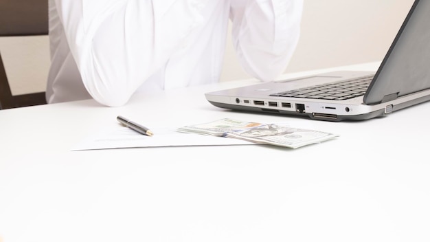 Man sitting at office desk behind american dollars financial loan is ready