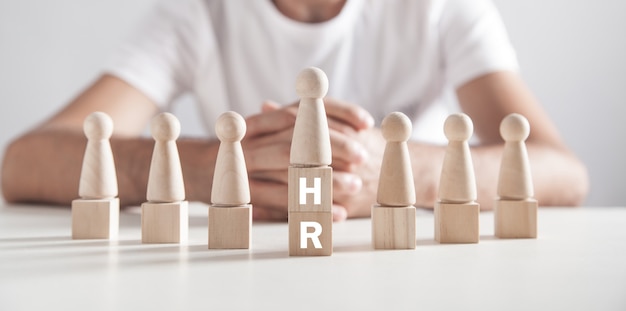 Photo man sitting in office. hr word on wooden cubes. human resources