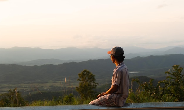 Man sitting watching the scenery of the ridge linecopy space