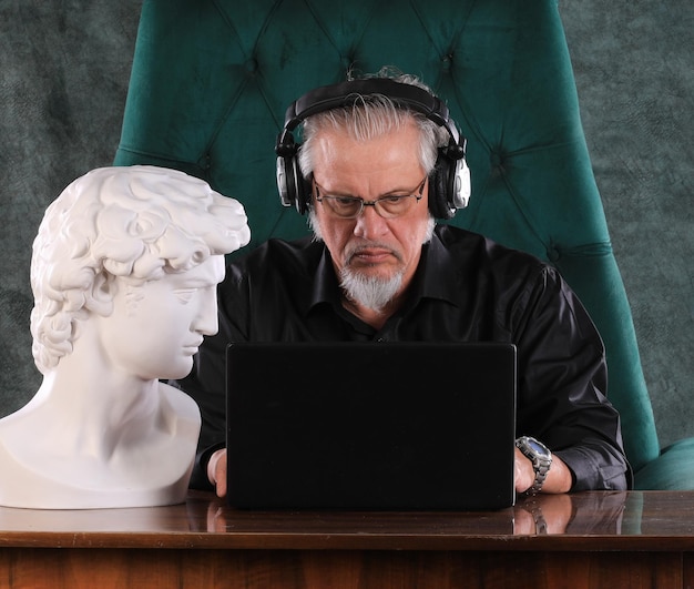 man sitting with laptop at night