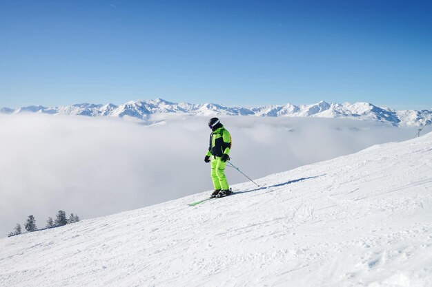 Man Skier in Zillertal Arena ski resort in Zillertal in Tyrol. Mayrhofen, in Austria in winter in Alps. Person at Alpine mountains with snow. Downhill fun. Blue sky and white slopes at Zell am Ziller.