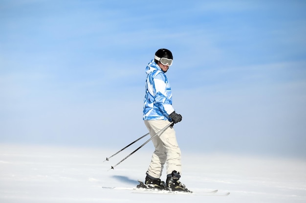 Man skiing on piste at snowy resort Winter vacation