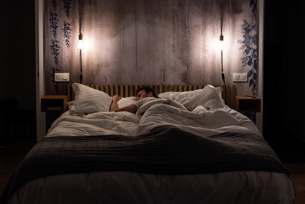 Man sleeping in bed in a modern beautiful bedroom