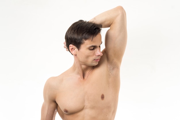 Man smelling his armpit with white background