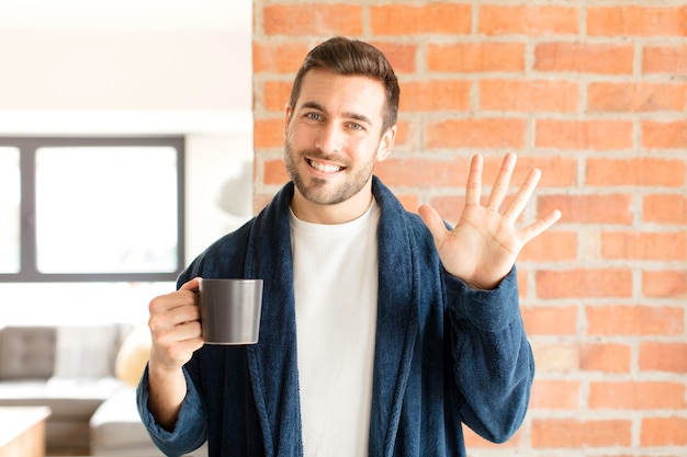 man smiling and man looking friendly, showing number five or fifth with hand forward, counting down