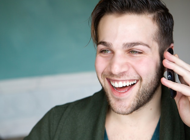 Man smiling using mobile phone